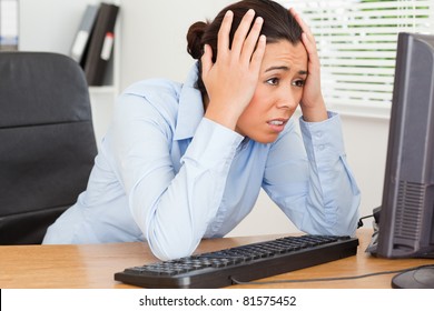 Good Looking Upset Woman Looking At A Computer Screen While Sitting At The Office