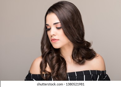 Good looking woman with long luscious hair wearing off shoulders