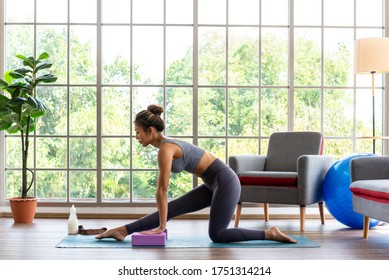 Good Looking Woman Practicing Yoga At Home Use Block For More Comfortable And Easier For Practise