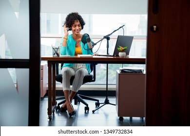 Good Looking Young Black Female Making An Online Podcast Recording For Her Online Show. Attractive Millennial African American Business Woman Using Headphones In Front Of Microphone For Radio Program.