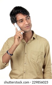 Good Looking Young Indian Boy Talking On A Cell Phone