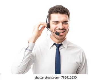 Good Looking Young Latin Man Working As A Sales Rep In A Call Center And Talking To A Customer With A Smile