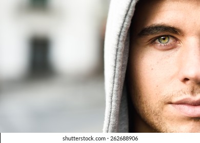 Good Looking Young Man With Blue Eyes In The Street Wearing Hooded Jacket