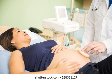 Good looking young pregnant woman getting an ultrasound in a hospital