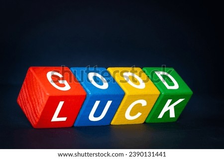 Good Luck symbol. Positive multicolored wooden blocs with the words Good Luck. Beautiful navy blue background, business and good luck concept. Copy space