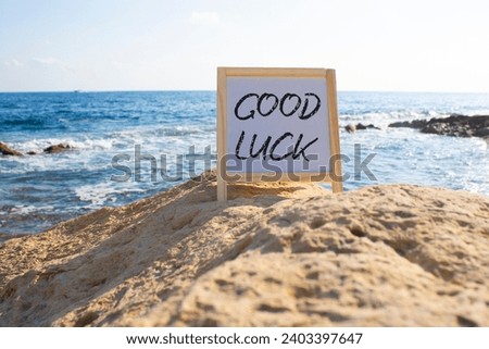 Good luck symbol. Good luck white chalk blackboard. Beautiful sea background. Business and Good luck concept. Copy space.