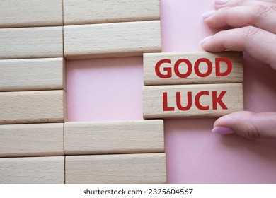 Good luck symbol. Wooden blocks with words Good luck. Businessman hand. Beautiful pink background. Business and Good luck concept. Copy space. - Shutterstock ID 2325604567