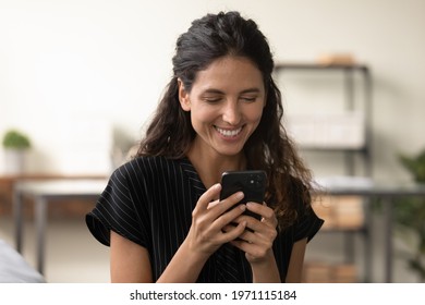 Good Message. Smiling Young Hispanic Lady Reading Positive News In Email On Phone Screen At Home Or In Office. Happy Millennial Latin Woman Enjoy Chatting In Social Media Relax Online Playing Web Game