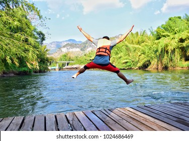 The good moment a man put on life jacket jumping into the river, holiday concept. - Powered by Shutterstock