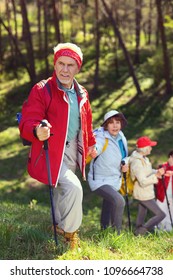 Good Mood. Happy Old Man Hiking With His Friends And Looking Around