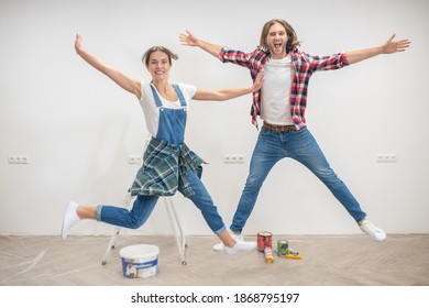 Good mood. Young couple jumping and feeling enjoyed - Shutterstock ID 1868795197