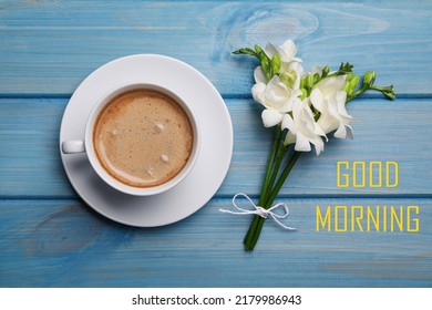 Good Morning! Aromatic Coffee And Flowers On Light Blue Wooden Table, Flat Lay