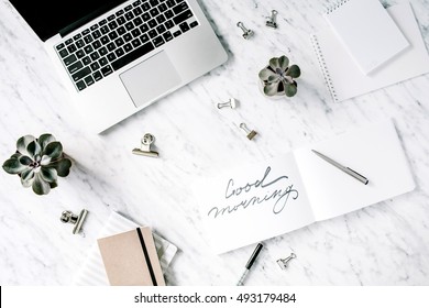 Good Morning. Flat Lay, Top View Office Table Desk. Workspace With Laptop, Diary, Succulent And Clips On Marble Background.