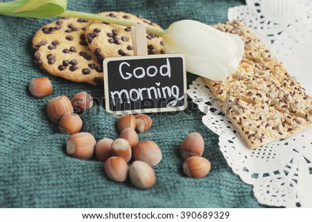 Good morning. Goodmorning blackboard. Rustic morning. Cookies on knitted background. White tulip. 