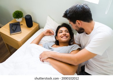 Good Morning, Love! Hispanic Boyfriend Smiling To His Girlfriend After Waking Her Up. Happy Couple Sleeping Together In A Comfy Bed