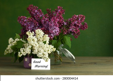 Good Morning Note And Lilac Flower On The Wooden Table