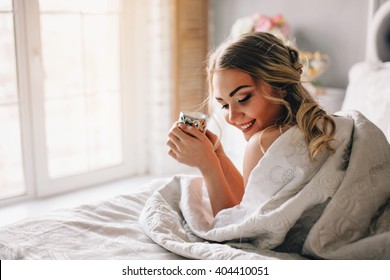 Good Morning! Woman Woke Up In Bed. Woman Drinking Coffee In Bed 