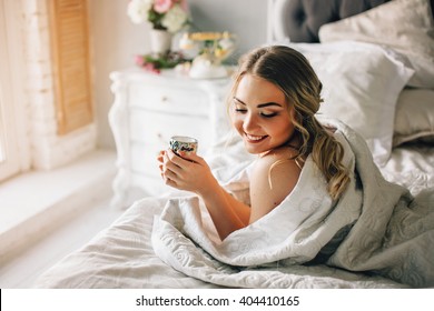 Good Morning! Woman Woke Up In Bed. Woman Drinking Coffee In Bed 