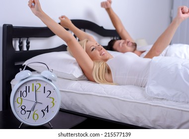 Good Morning! Young Couple Wake Up In The Morning In Her Bedroom, Lifting Your Hands Up