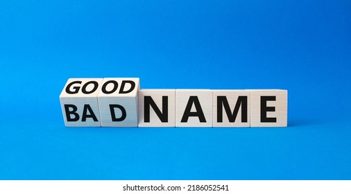 Good name and bad name symbol. Turned cubes with words Bad name and Good name. Beautiful blue background. Businessman hand. Business concept. Copy space