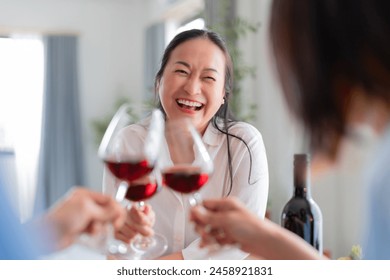 good old friend visit home asian mature woman friend talking standing in kitchen positive conversation good relation friendship reunion home visit casual relax hand hold wine glass goodvibe at home - Powered by Shutterstock