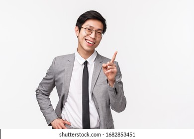 Good point. Waist-up portrait of impressed handsome asian businessman shaking index finger as praising coworker for great idea, smiling nod approval, agree or like something, white background