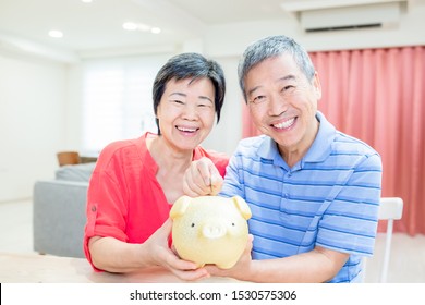 Good Retire plan concept - eldely couple hold piggy bank smile happily at home - Powered by Shutterstock