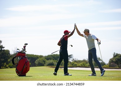 Good shot buddy. Shot of two happy men playing a game of golf.