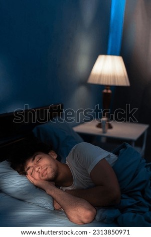 Good sleep concept. Handsome young man sleeping in comfortable bed alone at home, enjoying his orthopedic mattress and pillow, copy space.