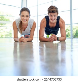 Good Things Come To Those Who Plank. Shot Of A Sporty Young Couple Doing Planking Exercises Together.