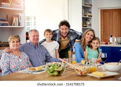 Good Times Are Always On The Menu At Family Gatherings. Portrait Of A Multi Generational Family Enjoying A Meal Together At Home.