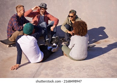 Good Times With Friends. Shot Of A Group Of Friends Sitting In The Sun At A Skate Park.