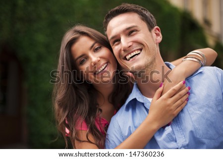 Similar – Image, Stock Photo Joyful couple laughing together on a vintage sofa