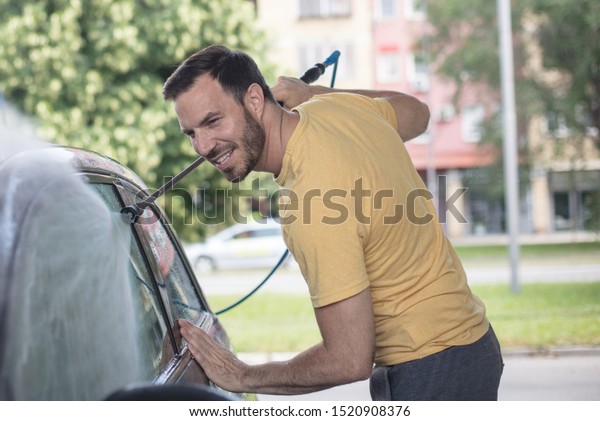 Good washing. Man washing\
car.