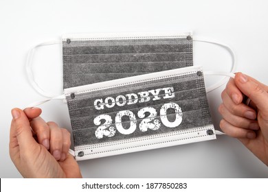 Goodbye 2020. Business, education, health and review concept. Two face masks on a white background