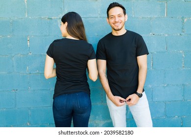 Good-looking couple wearing matching black t-shirts with a beautiful design in the front and back
