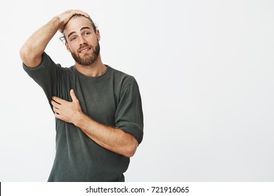 Good-looking Man With Stylish Hairstyle And Beard With Happy Expression Finally Can Breathe Easier After Finding Phone Under Table In Cafeteria.