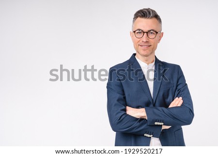 Good-looking middle-aged businessman with arms crossed isolated in white background
