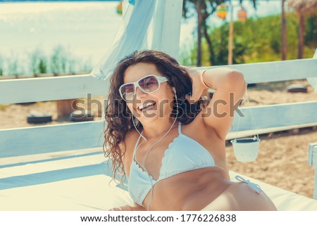 Similar – Brunette surfer woman in bikini standing with surfboard