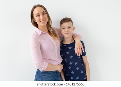 Good-looking Single-parent Mom And Teen Son On White Background. Cohesion, Friendship And Family Relations.