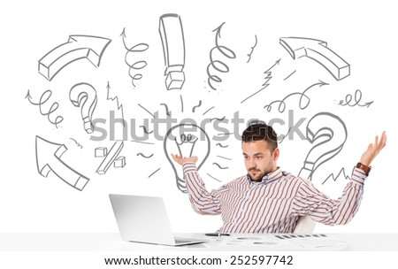 Good-looking young businessman brainstorming with drawn arrows and symbols