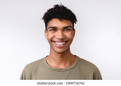 Good-looking young mixed-race man in casual clothes smiling with teeth isolated over white background