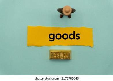 goods.The word is written on a slip of paper,on colored background. professional terms of finance, business words, economic phrases. concept of economy. - Shutterstock ID 2173785045
