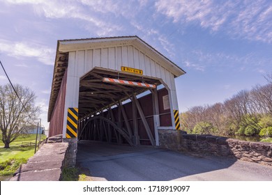 Goodville, PA / USA - April 28 2020: Weaver’s Mill Covered Bridge spans the Conestoga River in eastern Lancaster County, PA.