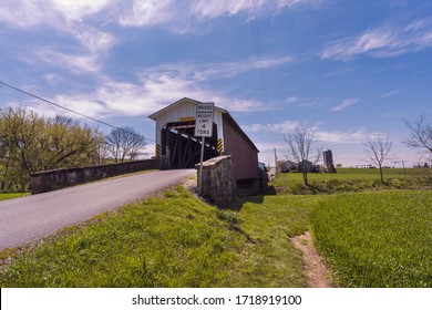 Goodville, PA / USA - April 28 2020: Weaver’s Mill Covered Bridge spans the Conestoga River in eastern Lancaster County, PA.