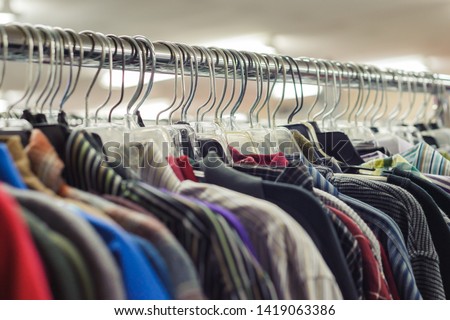 Goodwill is an American nonprofit organization and a second-hand store that creates jobs. Items donated to the thrift store are resold to the public. Retail coat hangers merchandised on racks in store