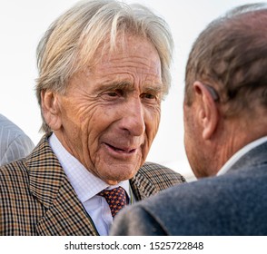 Goodwood, Sussex / UK - 14 Sept 2019: Veteran Racing Driver Derek Bell Talks To Jochen Mass During The Credit Suisse Forum At Goodwood Revival. The 77 Year Old Looks Happy, Smiling With A Twinkle.