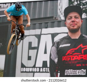 Goodwood, Sussex, UK - 8 July 2021:Festival Of Speed High Adrenaline Display By A BMX Stunt Bike Rider Performing In Front Of A Giant Video Screen Showing Live Action At The Goodwood Action Stadium (GAS). 