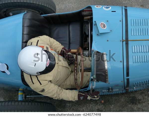 Goodwood, UK - 17th April 2017: Bugatti Type 35\
driver waiting in anticipation to select a gear and wheel spin off\
to start the race.