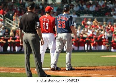 GOODYEAR, AZ - MARCH 5: The Reds' Joey Votto Holds The Indians' Austin Kearns On First Base During A Cactus League Game March 5, 2010 At Goodyear Ballpark, Goodyear, Arizona. Umpire D.J. Reyburn Looks On.